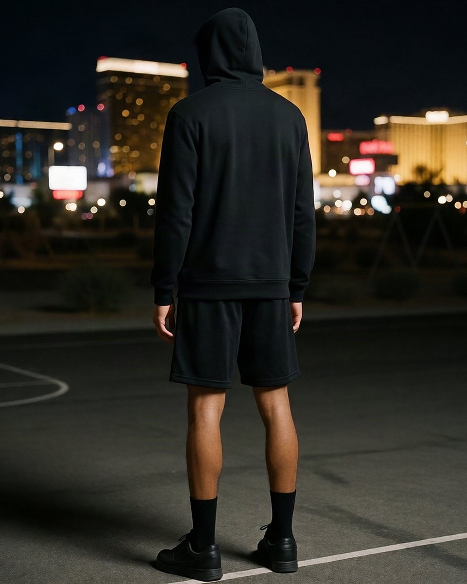Levone from behind, hood up, on an empty court at night in Las Vegas